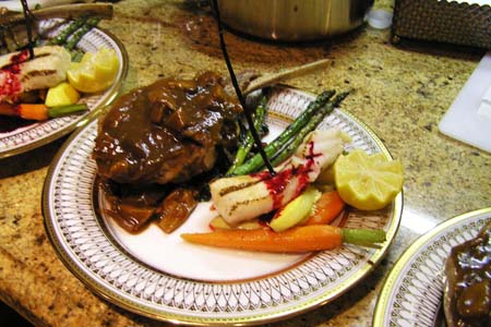 Veal Chop with Morel Sauce Over Red Cabbage Confit and Grilled Sea Bass with Cumin Glazed Carrots and Grilled Asparagus